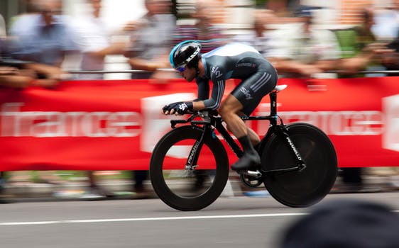 A dyslexic cyclist is racing on a track at high speed.
