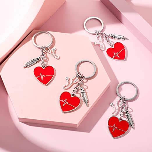 24 Pcs Nurse Party Favors Nurse Keychain with Heart Pendant Appreciation Thank You Nursing Gifts for Nurses Week, pink background.