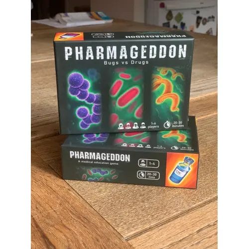 Pharmageddon: Bugs vs Drugs, A Medical Education Antibiotic Card Game boxes on a table.