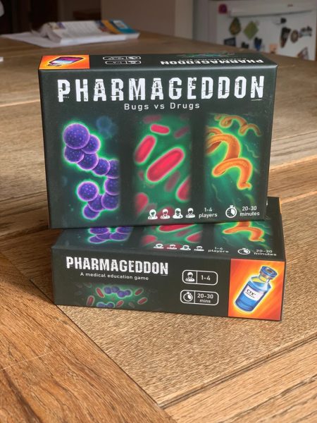 Pharmageddon: Bugs vs Drugs, A Medical Education Antibiotic Card Game boxes on a table.